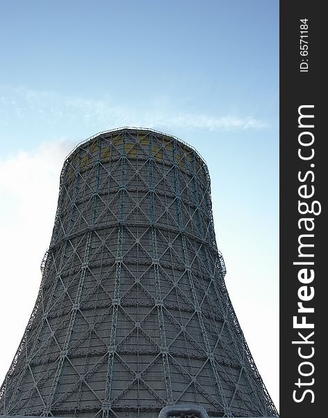 The evaporating cooling tower against the sky. The evaporating cooling tower against the sky