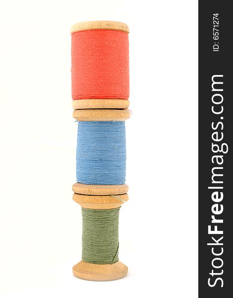 Isolated green, blue & red spool on white background. Isolated green, blue & red spool on white background