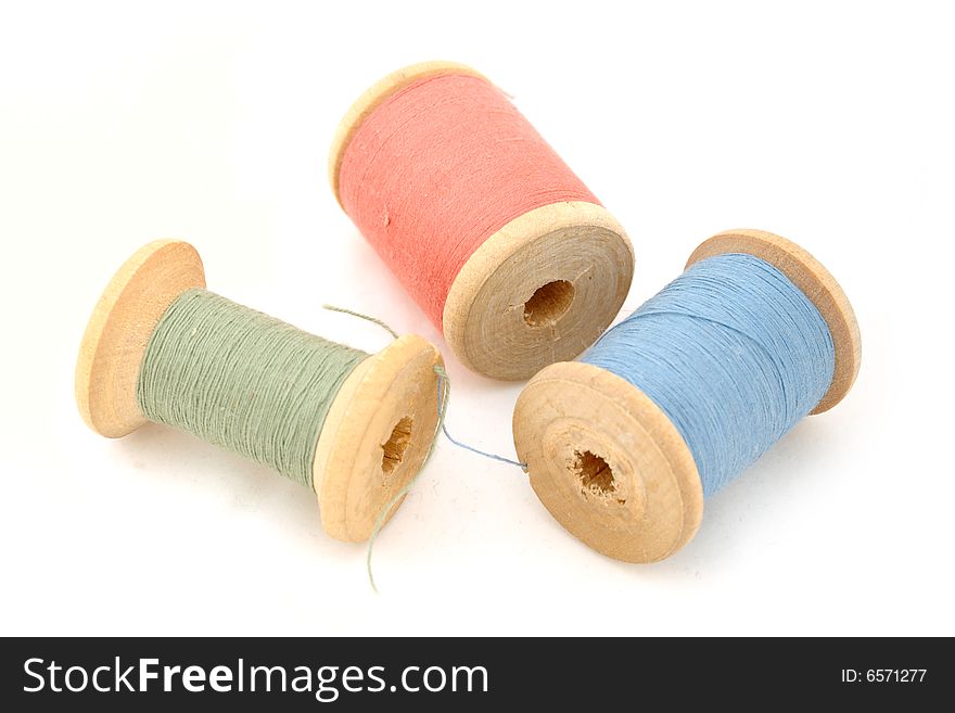 Isolated green, blue & red spool on white background. Isolated green, blue & red spool on white background