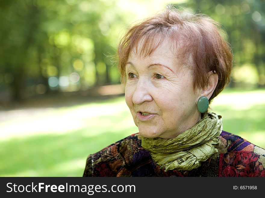 Happy senior woman relaxing in park