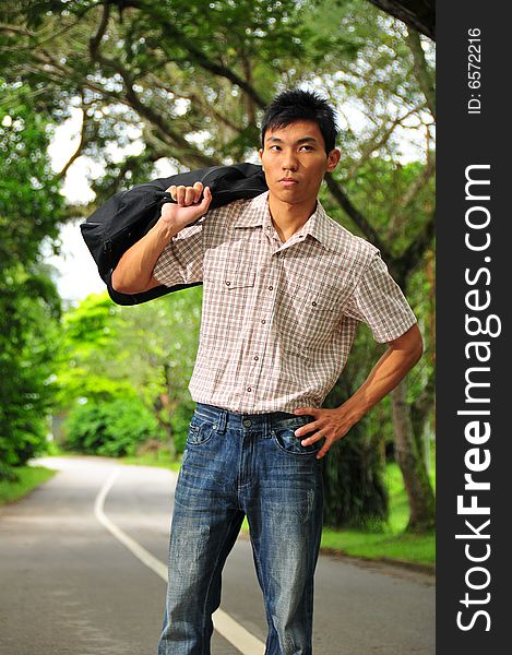 Picture of an Asian Hitchhiker. Suitable for cross country picture or the context of how someone should move ahead. Suitable for holidat, casual picture as well. Picture of an Asian Hitchhiker. Suitable for cross country picture or the context of how someone should move ahead. Suitable for holidat, casual picture as well.