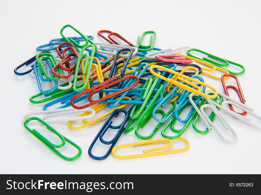 Colored paper-clips on a white background