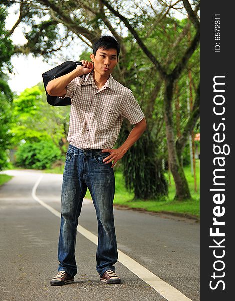 Picture of an Asian Hitchhiker. Suitable for cross country picture or the context of how someone should move ahead. Suitable for holidat, casual picture as well. Picture of an Asian Hitchhiker. Suitable for cross country picture or the context of how someone should move ahead. Suitable for holidat, casual picture as well.