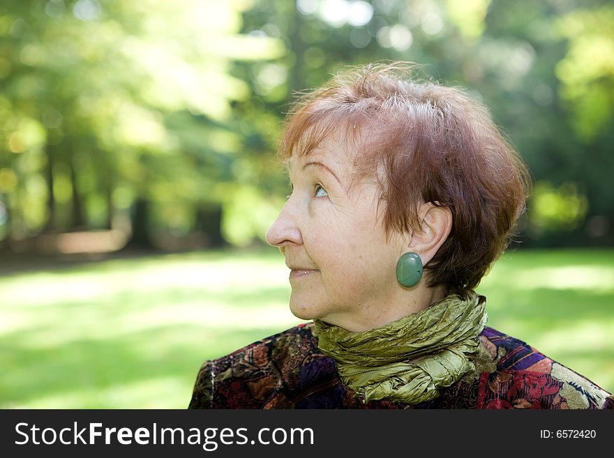 Happy senior woman relaxing in park