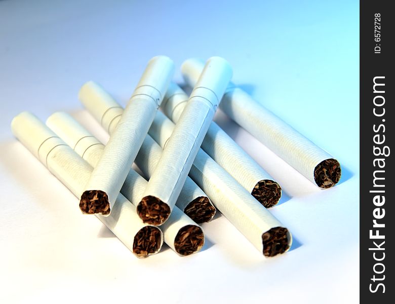 Close-up photo of white cigarettes on blue background