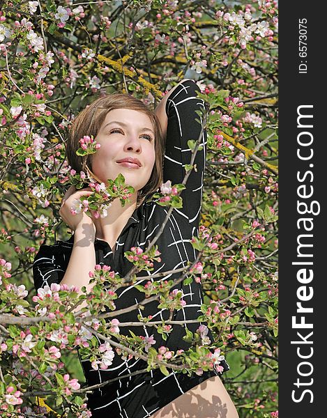 Nice girl on the flowering  apple-tree  background