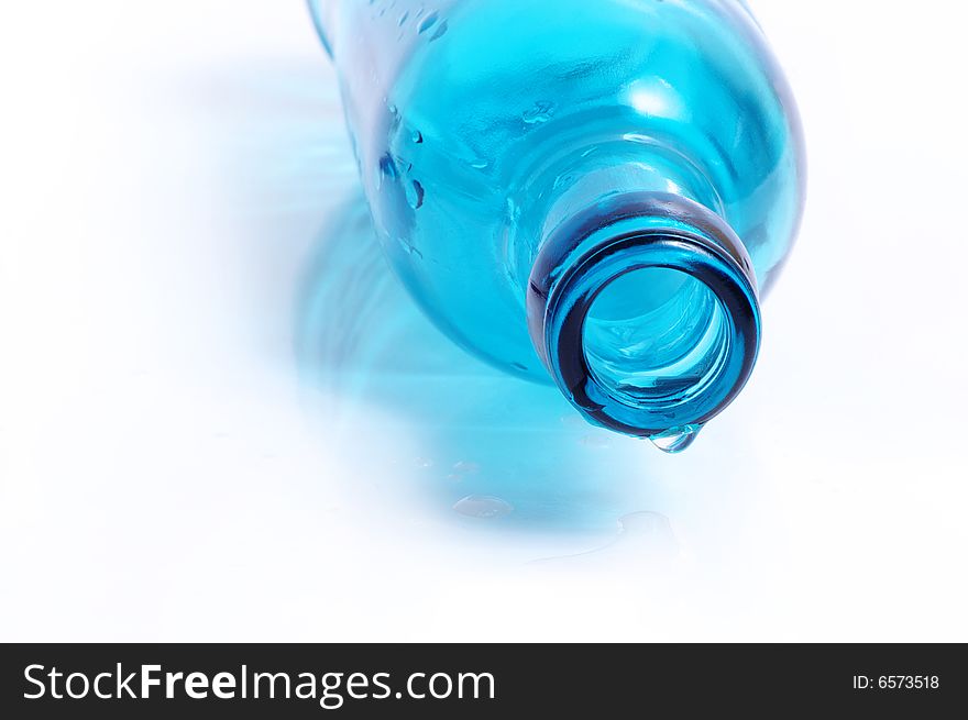 Throat of a blue bottle with a water drop