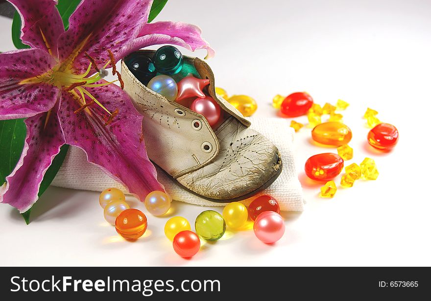 Bath oil in baby shoe and flower