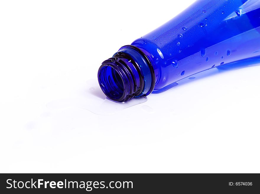 Darkly dark blue bottle with water drops