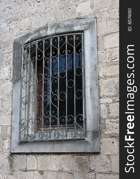 Grated window on old house