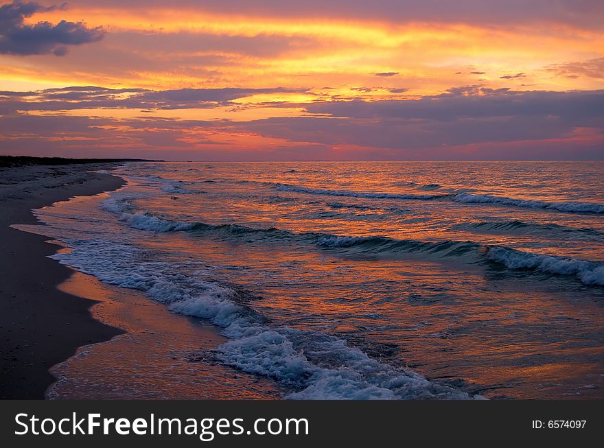 Sunset at seaside with waves