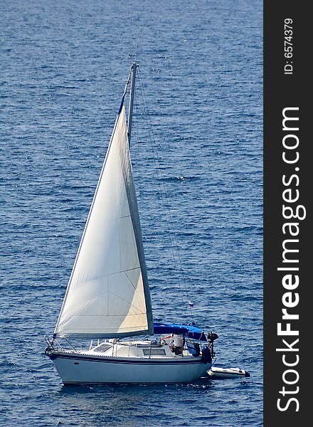 Photo of a yacht sailing in the Mediterranean sea. Photo of a yacht sailing in the Mediterranean sea