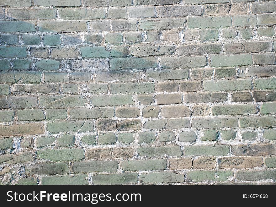 The  weathered colorful ancient brick wall of a Chinese old building. The  weathered colorful ancient brick wall of a Chinese old building.