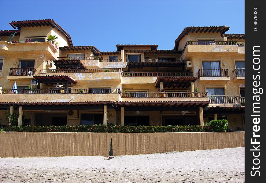 Sand colour resort building on a beach of Puerto Vallarta town, Mexico.