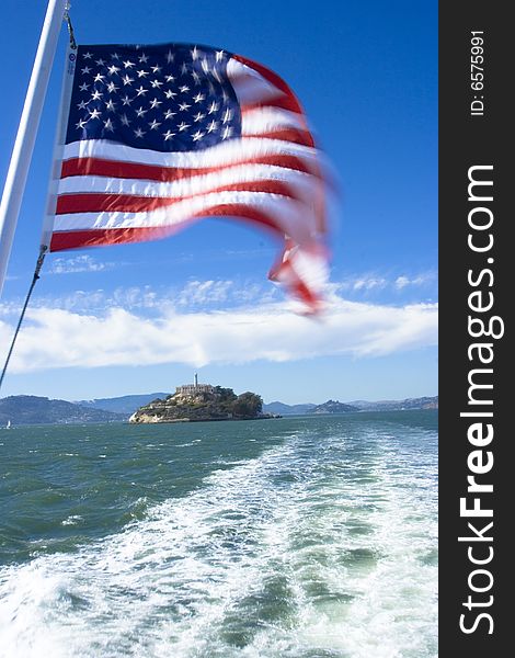 A american flag with alcatraz in the background