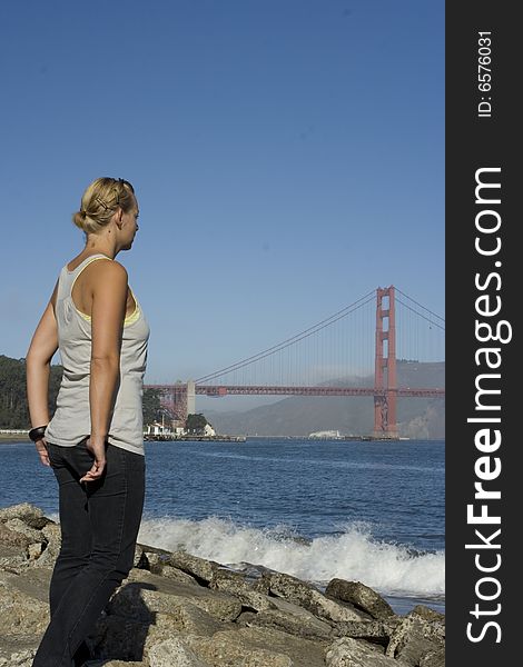 A woman staring at the golden gate bridge. A woman staring at the golden gate bridge