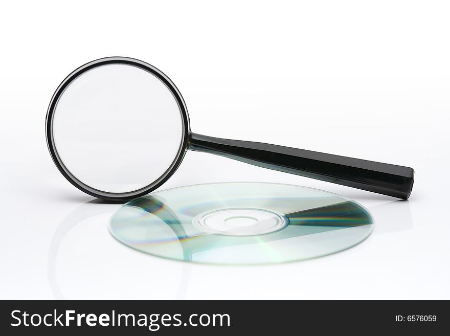 Searching on CD - magnifying glass and CD on light background