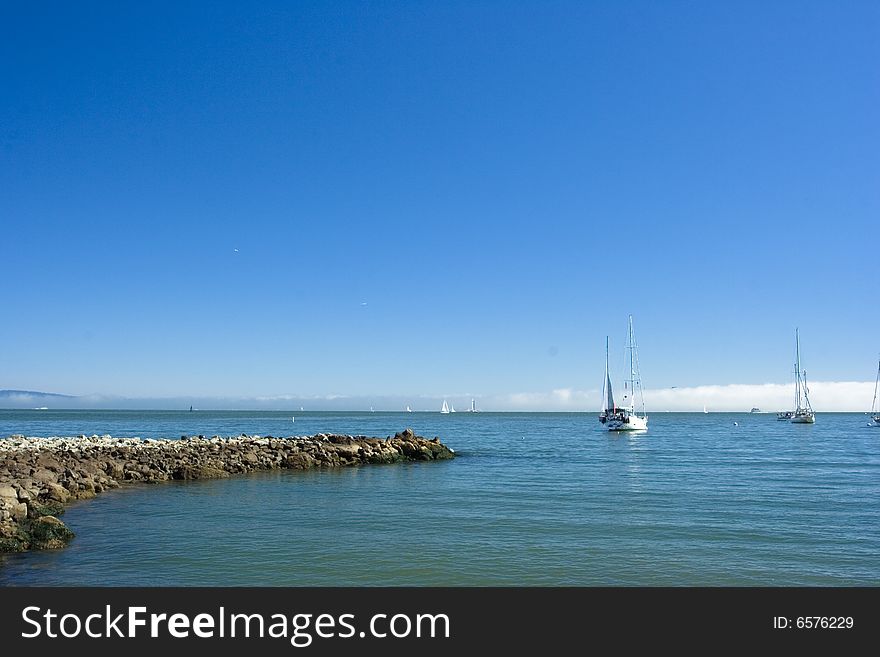 Sailboat in the water with a clear blue sky. Sailboat in the water with a clear blue sky