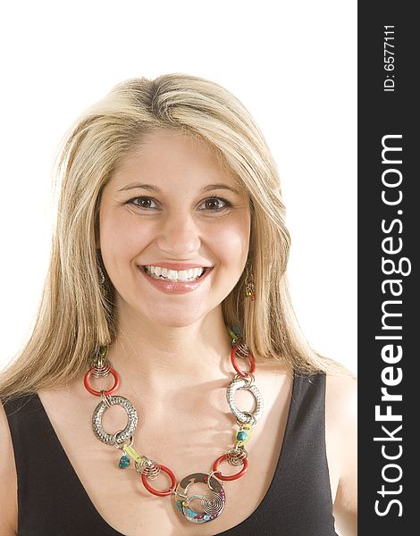 A young blonde in a black dress and colorful necklace with a big smile. A young blonde in a black dress and colorful necklace with a big smile