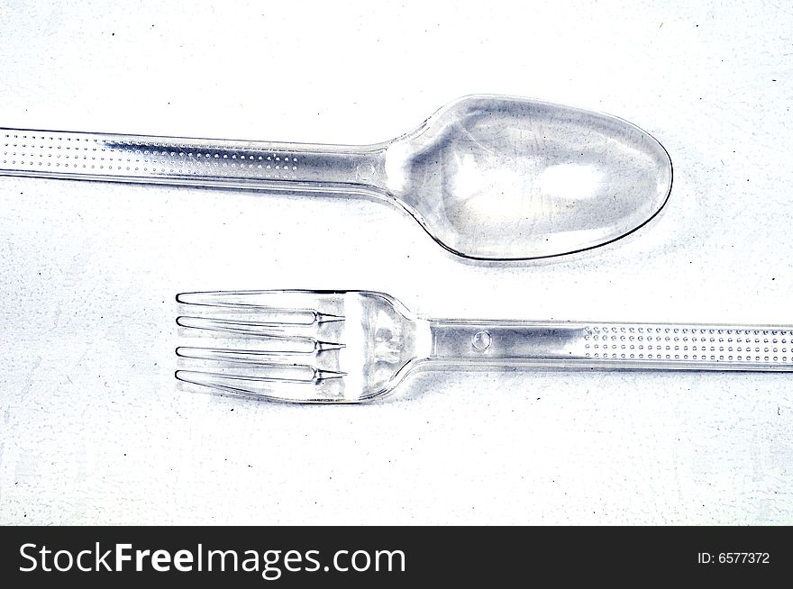 Plastic Spoon and Fork on a White Background