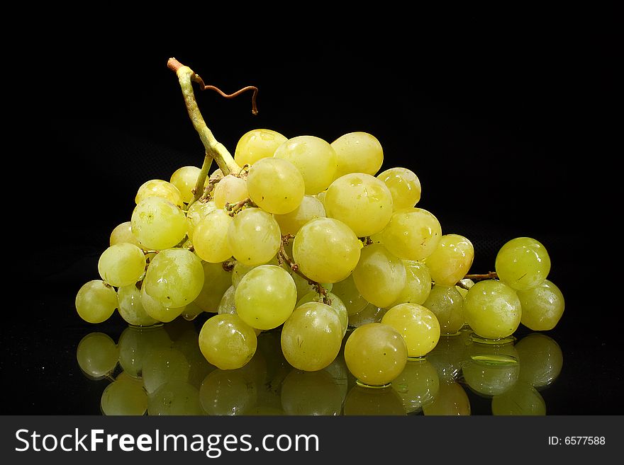 Green grapes on a dark background