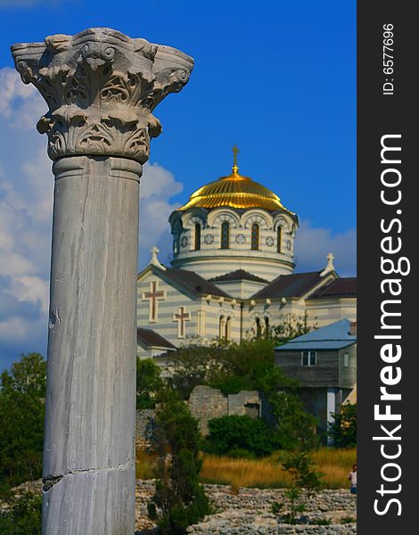 Column and church of the Chersonese on a sky background