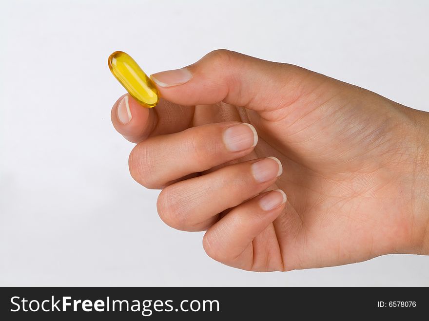 Lady's hand with a gel vitamin. Lady's hand with a gel vitamin