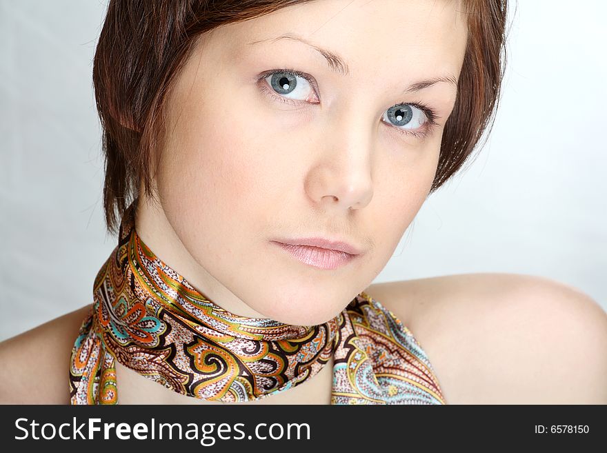 Portrait of a beautiful young woman with neck scarf