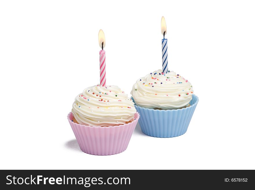 Two cupcakes with candle on white background