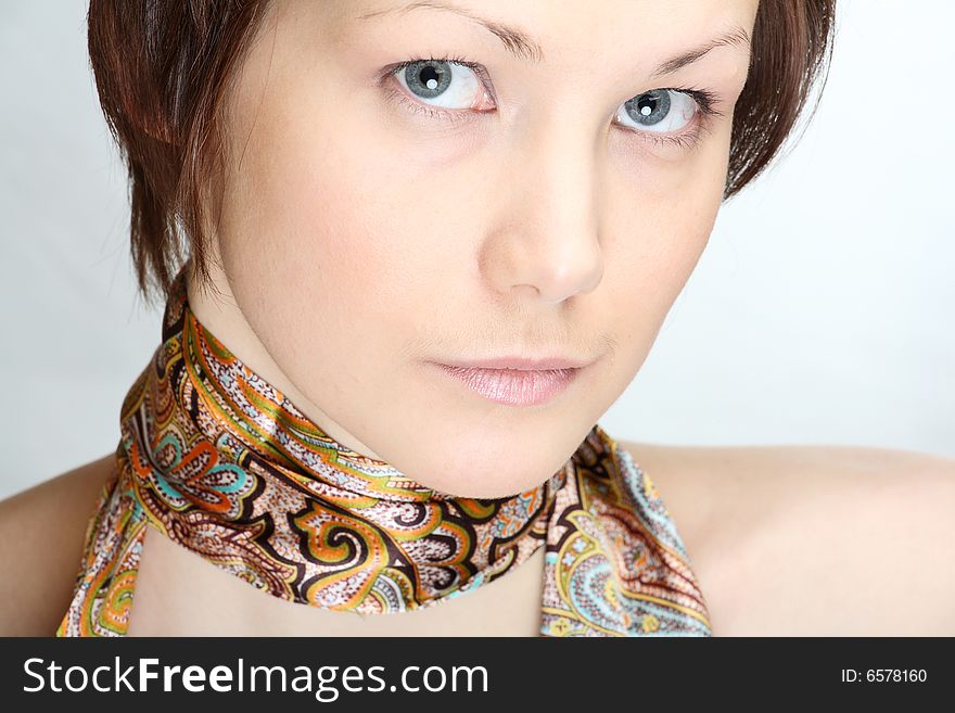 Portrait of a beautiful young woman with neckscarf