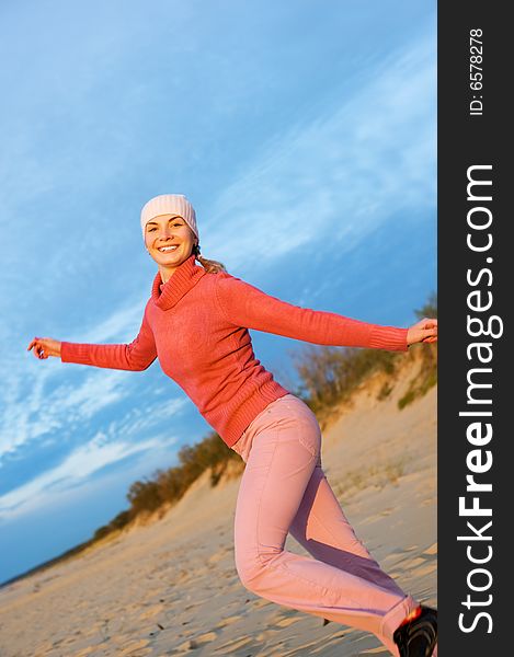 Beautiful young woman running on a beach. Beautiful young woman running on a beach