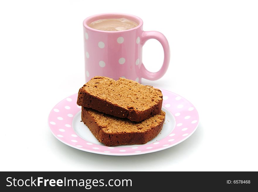 Shot of some cake and a cup of tea on white