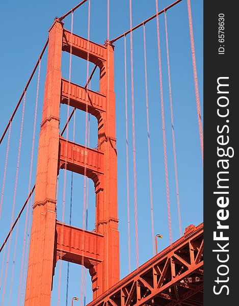 Golden gate bridge tower against blue sky