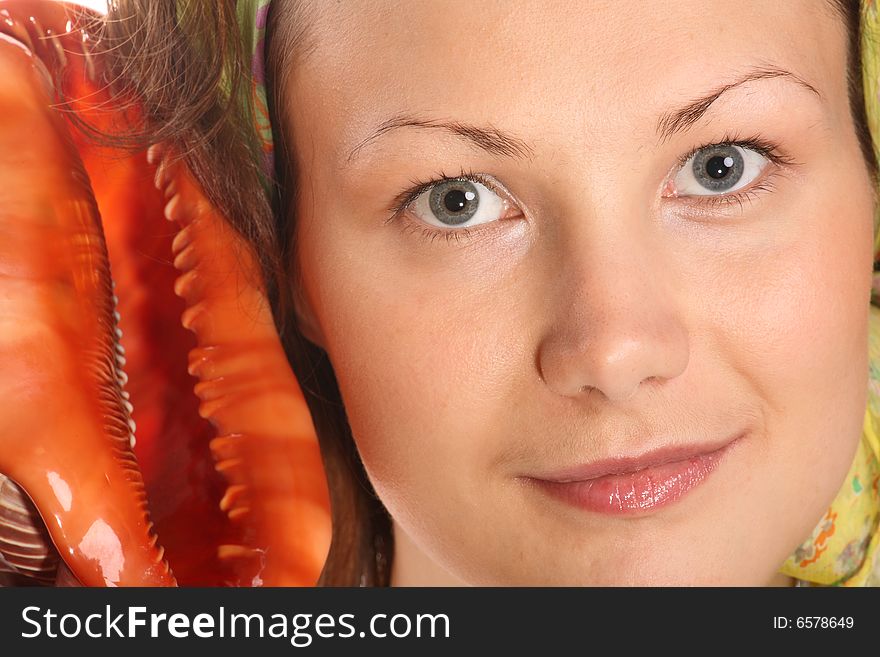 Portrait of Beautiful model with green headscarf and red sea shell