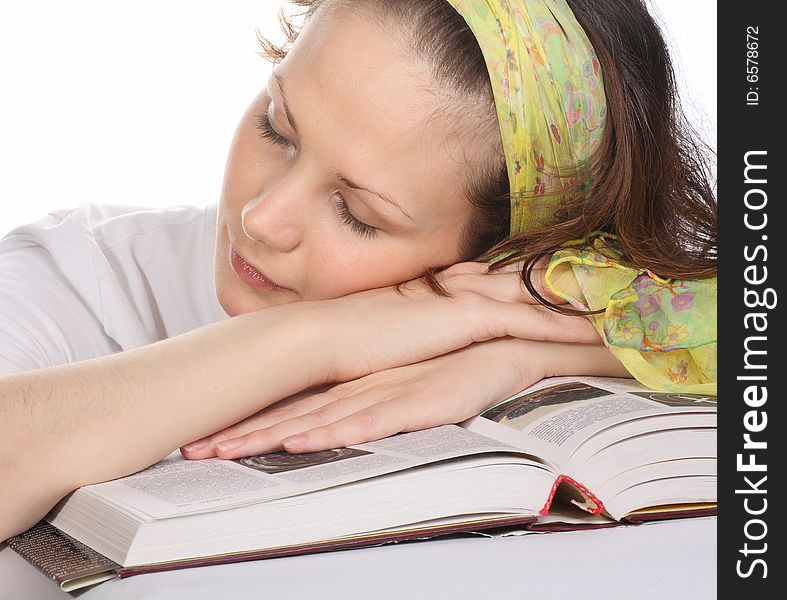 Beautiful girl with green headscarf sleeping on book. Beautiful girl with green headscarf sleeping on book