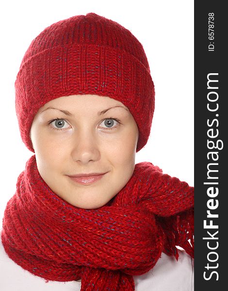 Beautiful girl with blue eyes in red knitted cap and scarf