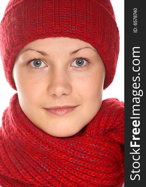 Beautiful girl with blue eyes in red knitted cap and scarf