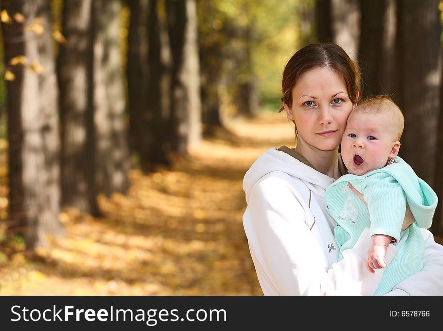 Mother and baby in the autumnal park