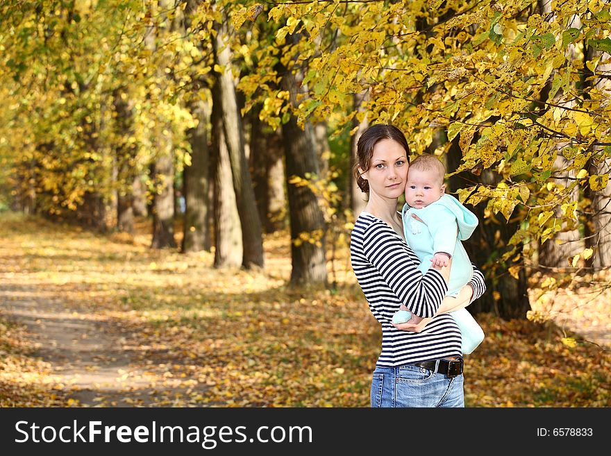 Mother and baby in the autumnal park