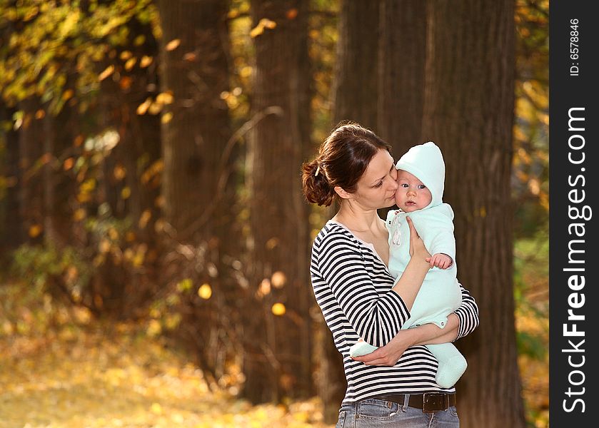 Mother and baby in the autumnal park