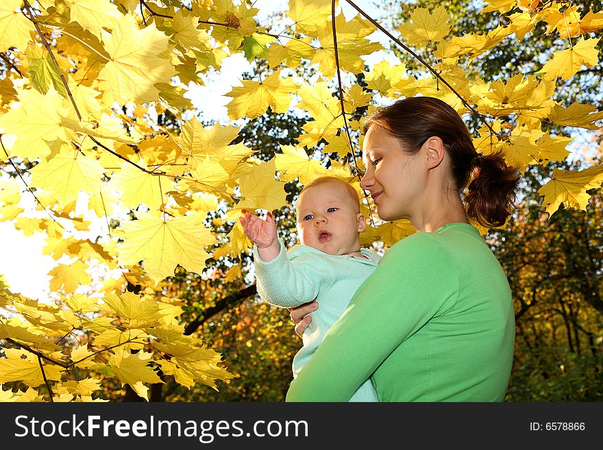 Mother and baby in the autumnal park