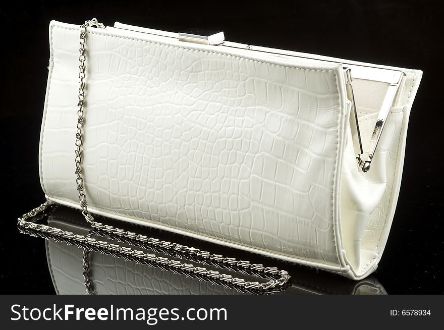 White woman's purse on black background