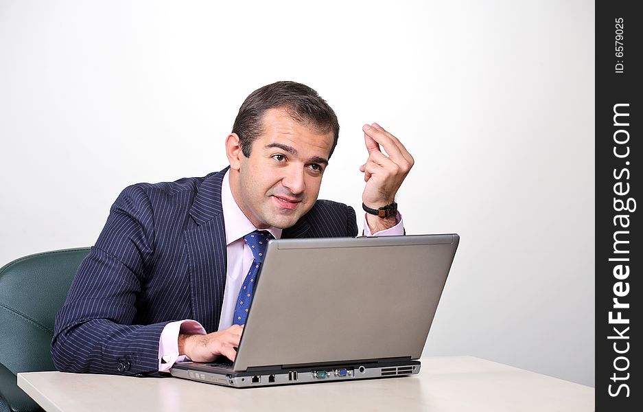 Emotional businessman working on laptop