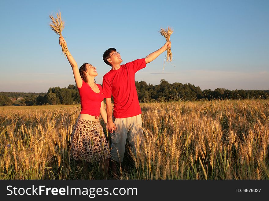 Pair In Field With Wheat In Hands