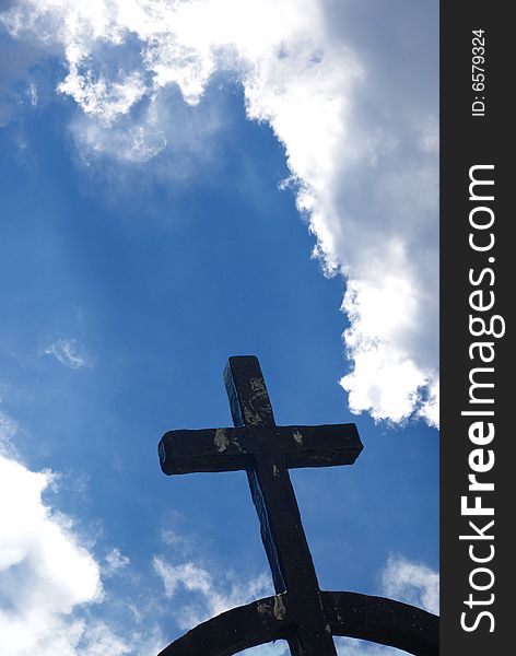 Iron cross against blue shining sky