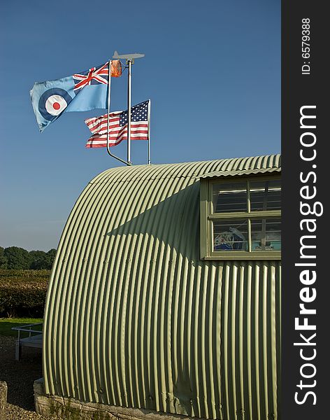 The allied flags fly over a wartime military building. The allied flags fly over a wartime military building