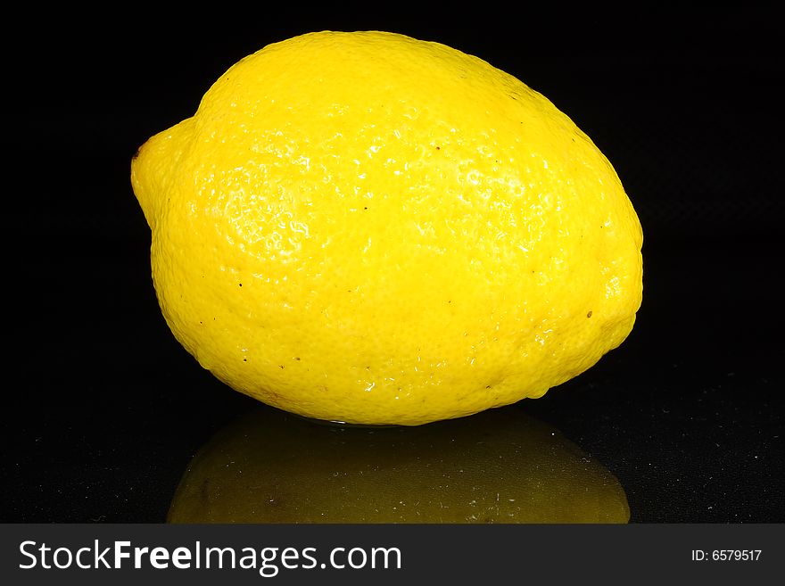 Bright lemon yellow juicy fruit on a dark background