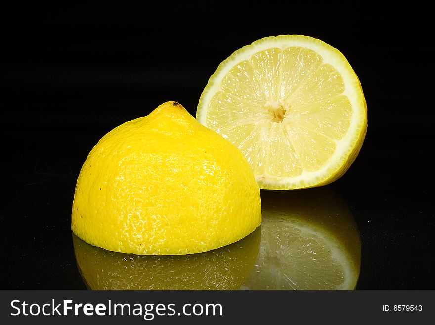 Bright lemon yellow juicy fruit on a dark background