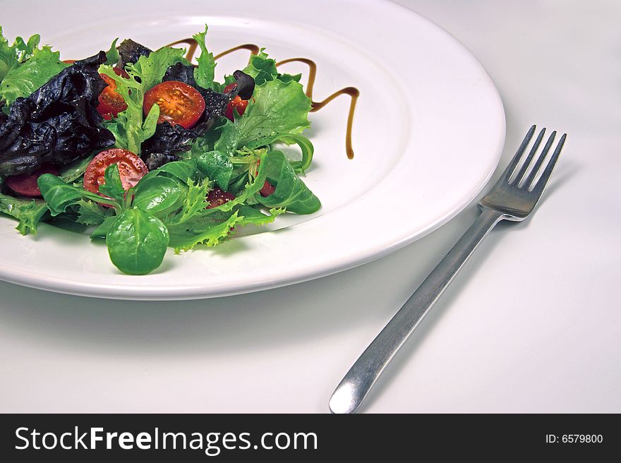 Green salad on a white plate