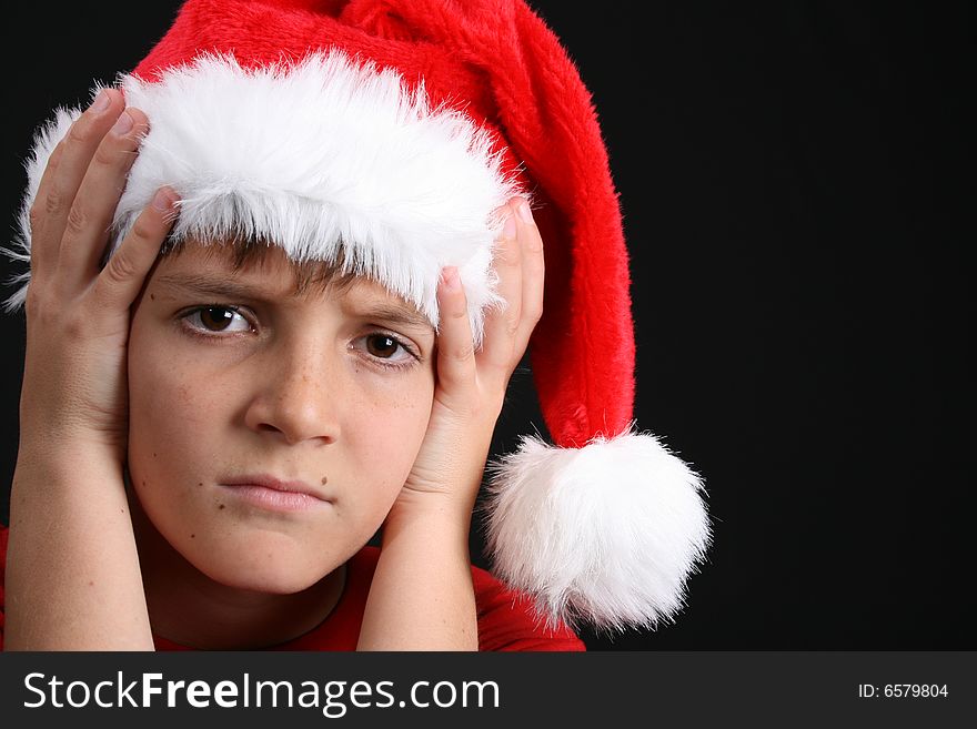 Young boy wearing a red shirt and christmas hat. Young boy wearing a red shirt and christmas hat